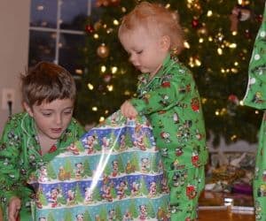 two boys opening a christmas gifts that aren't toys