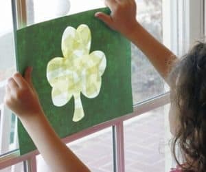 little girl hanging up her st. patrick's day shamrock craft