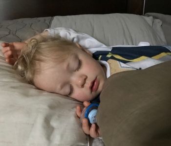 toddler asleep with pacifier in his hand -how to get rid of the pacifier!