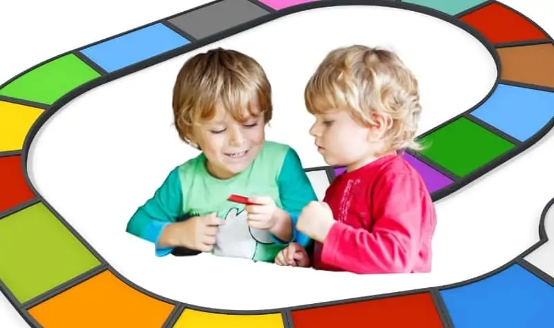 two three year olds playing a board game