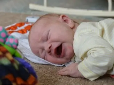 one month old baby crying during tummy time activities