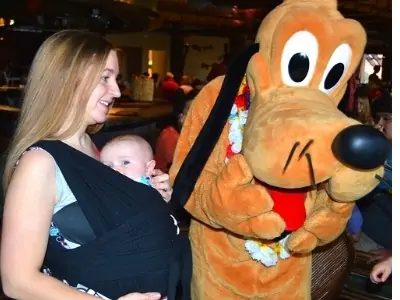 mom and 1 month old baby with Pluto at Disney
